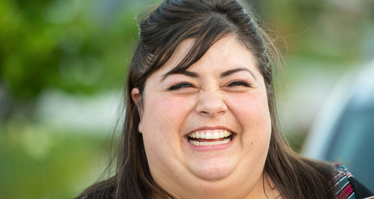 Closeup of caucasian female employee smiling at the camera