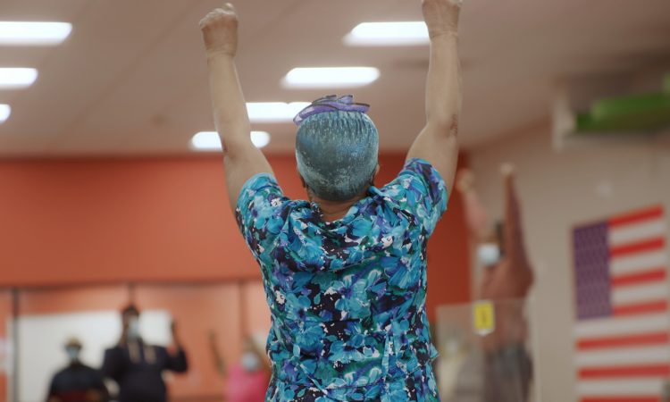 Senior woman raising her arms in celebration
