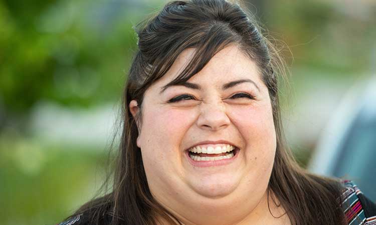 Closeup of caucasian female employee smiling at the camera