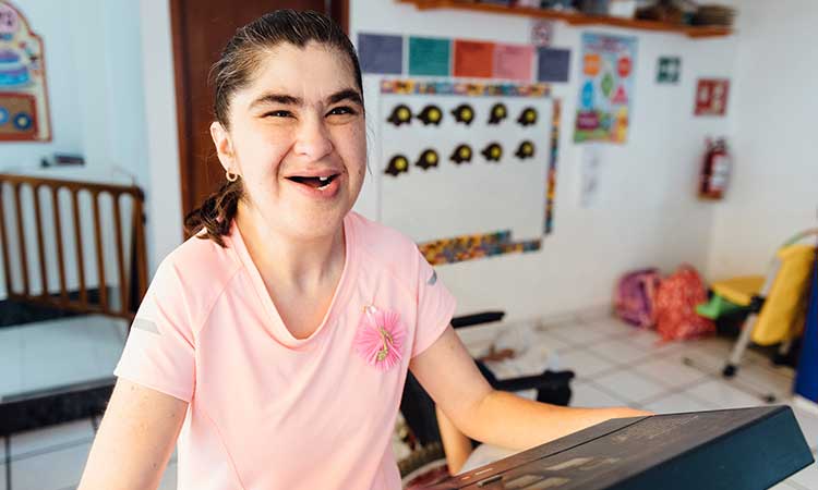 Young woman with disability exercising and having fun at day program