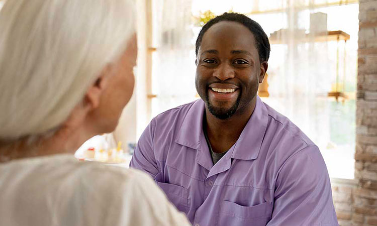 Male nurse smiling with female patient