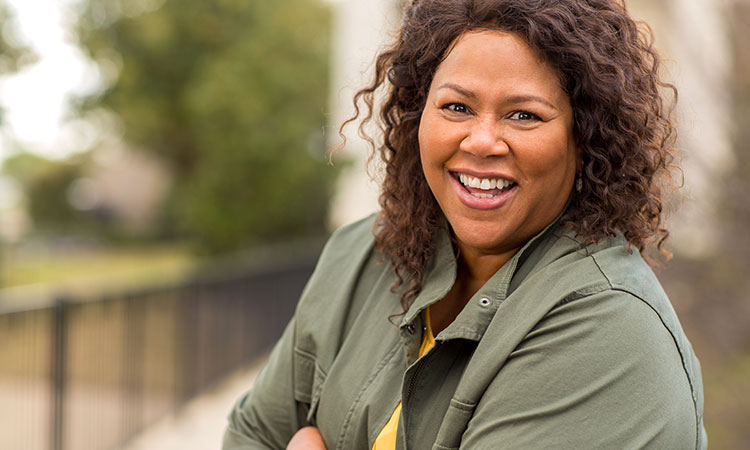 Closeup of woman smiling on a porch outside