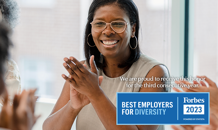 Employee clapping her hands in a meeting. Image also contains the Forbes 2023 Best Employers for Diversity logo.