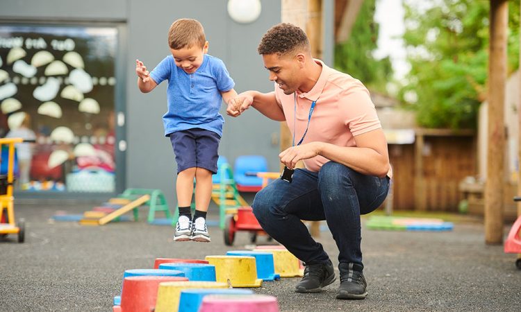 Young boy playing a game with his physical therapist