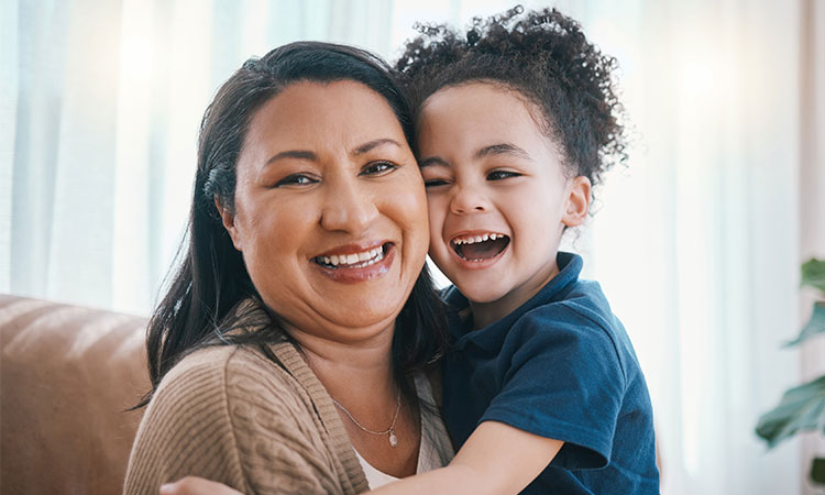 mom holding toddler daughter